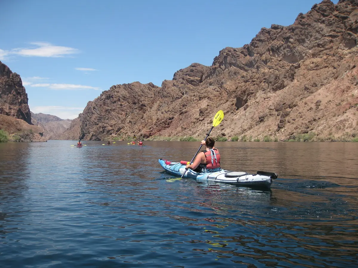 A kayaker on the Colorado River between canyon walls