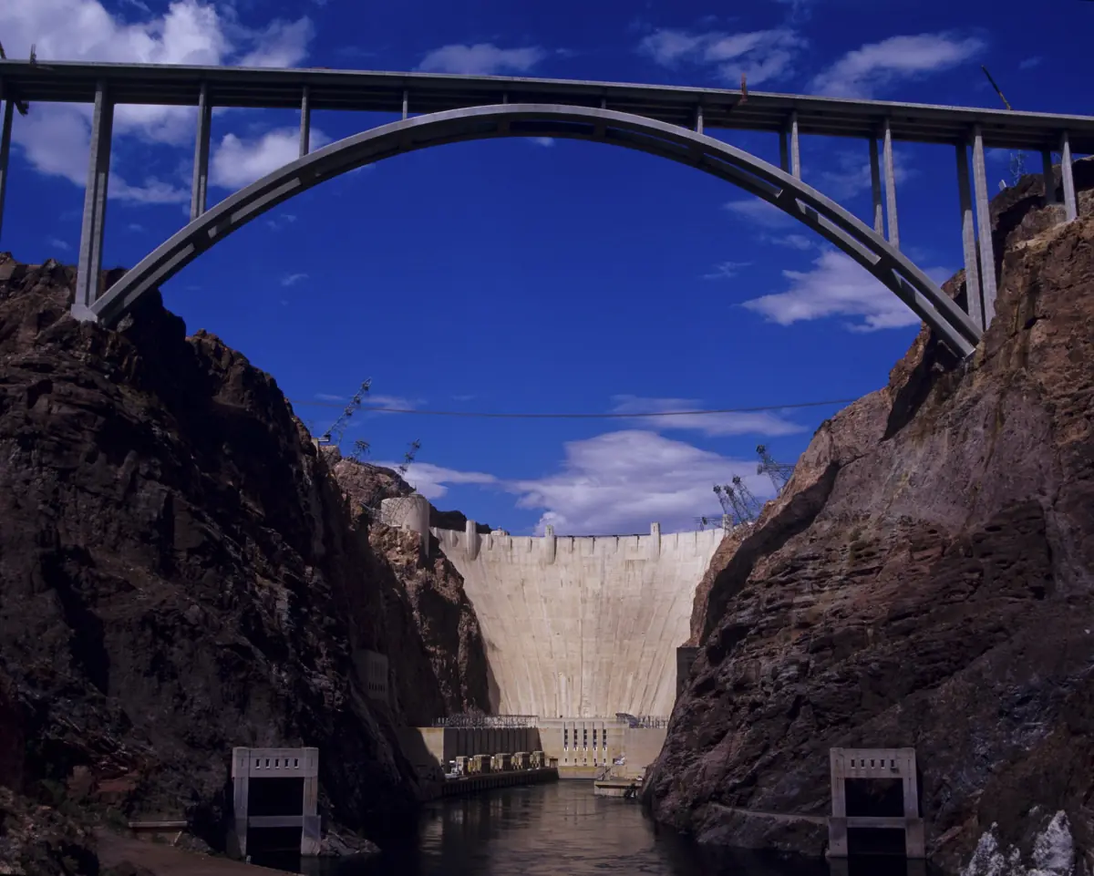 Hoover Dam with the arch of the bypass bridge downstream